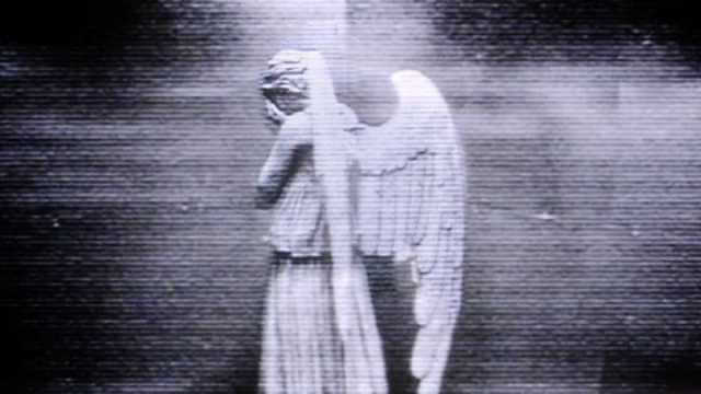 A screenshot of a weeping angel facing away with its hands over its face.