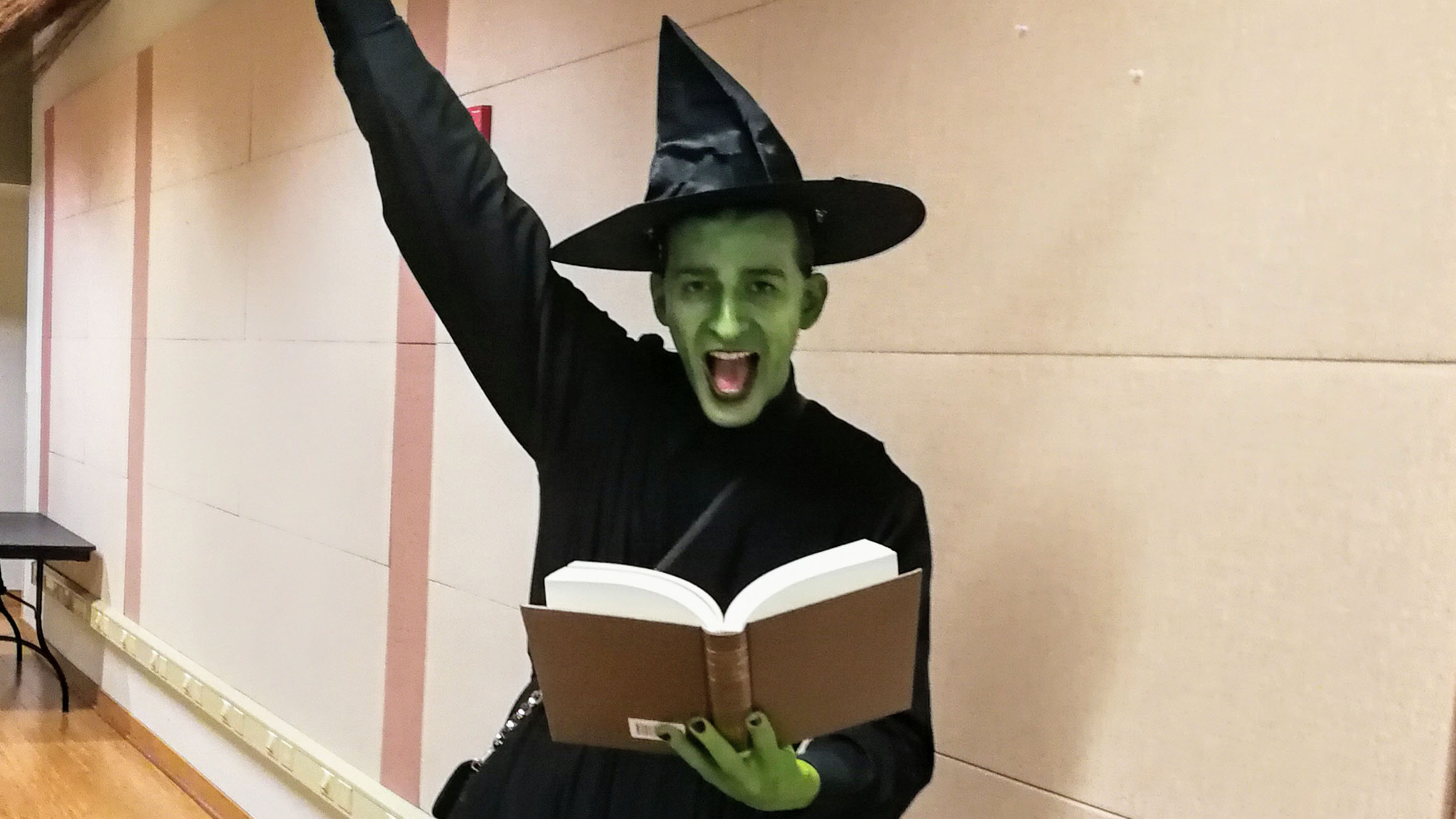 Thumbnail of Elphaba chanting a spell from a book.