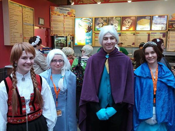 Four princess cosplayers stand together.