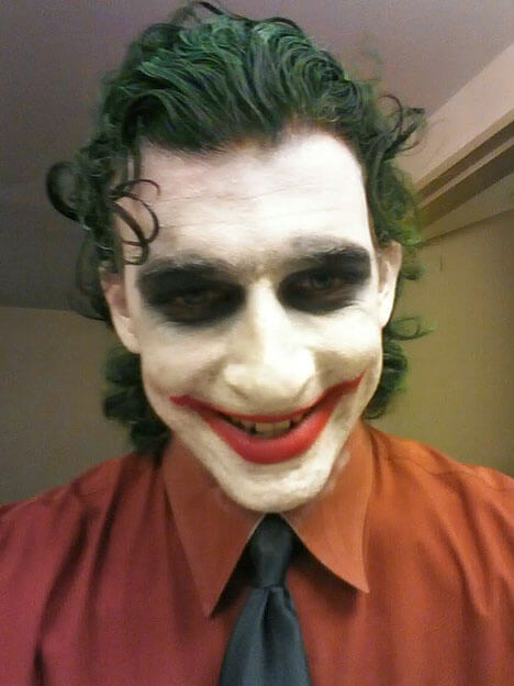 The Joker grins down at the camera.