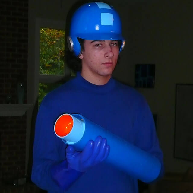 Mega Man holds his arm canon.