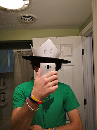 Zachary wears a tall paper crown prototype.