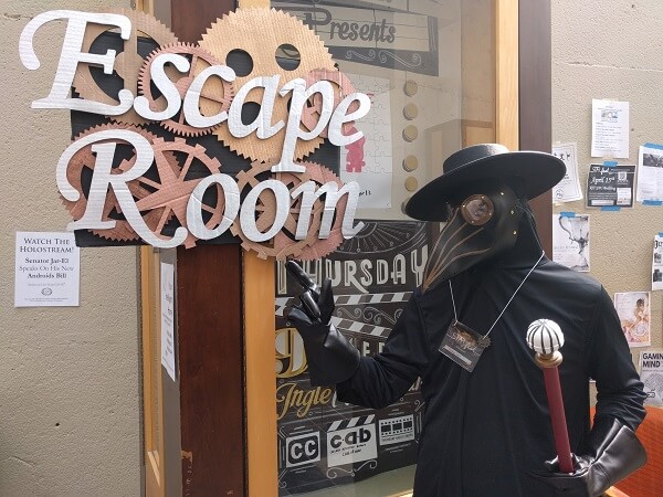 Zero II points to the Escape Room sign at STARfest 2017.