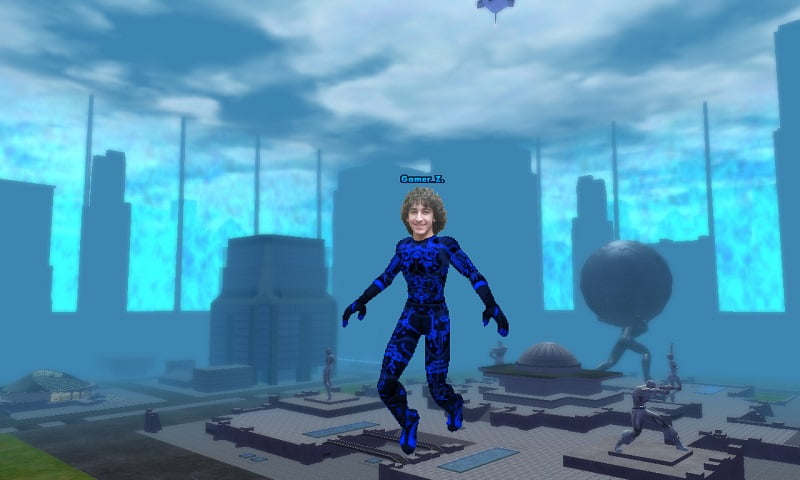 Zachary's head is edited onto xer City Of Heroes character's body, and both are edited to fly above a promo image of Paragon City.