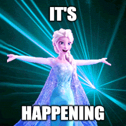 Elsa stands with her arms wide.  Lasers flash and text says, It's happening!